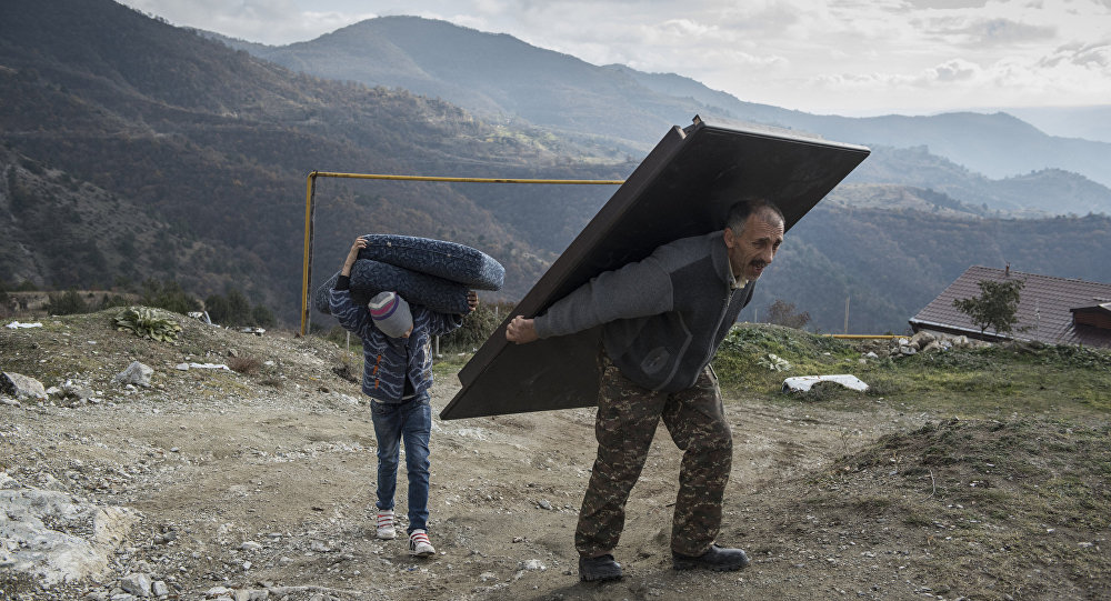 Paradise Lost. Murad Mvrgaryan and his son Vahak carry items from their home before leaving the town of Lachin, Nagorno-Karabakh. Paradise Lost. Murad Mvrgaryan and his son Vahak carry items from their home before leaving the town of Lachin, Nagorno-Karabakh.