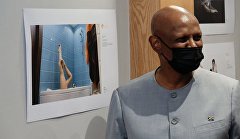 A visitor looks at photos during the opening ceremony of the Stenin Photo Contest exhibition in Pretoria, South Africa. 